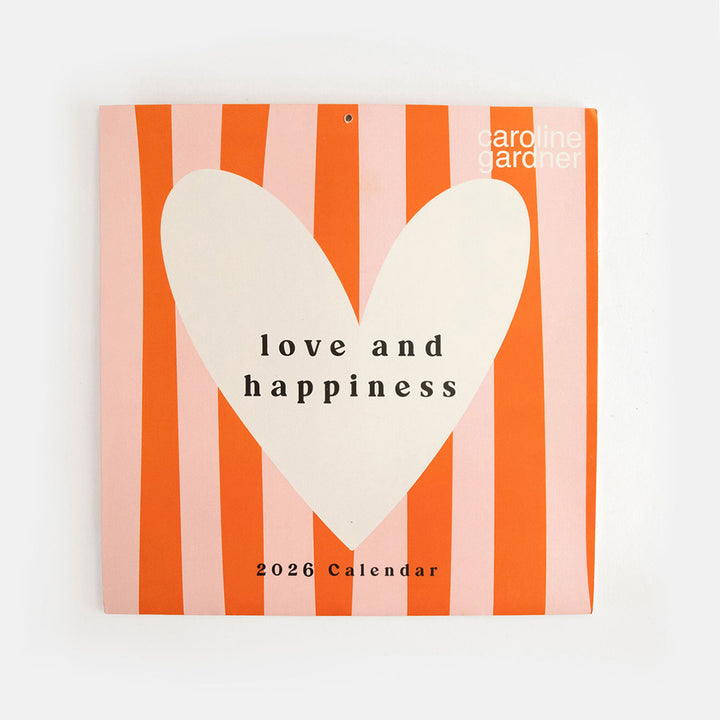 2026 wall calendar with front cover design of orange and pink stripes with white heart and the words love and happiness