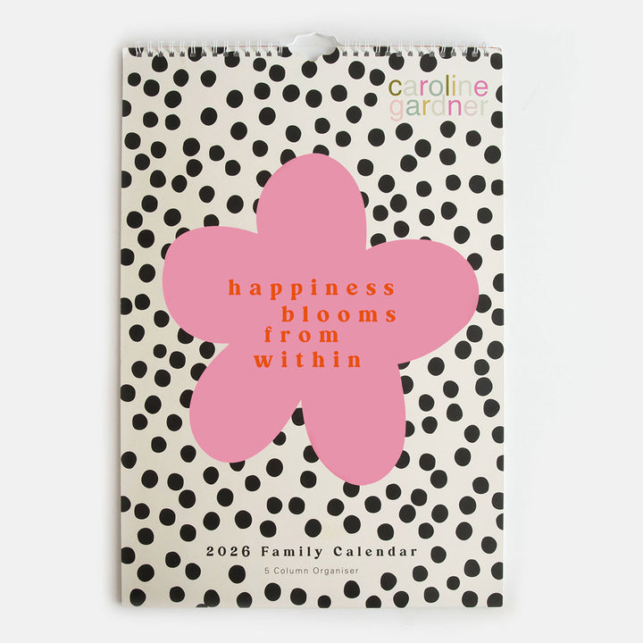 a3 family planning calendar with front cover featuring monochrome dots design with pink flower and the words 'happiness blooms from within'