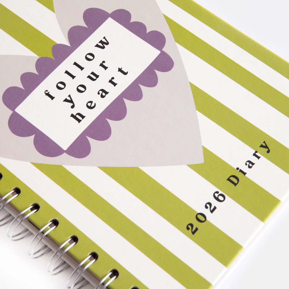 2026 wire bound diary with hardcover featuring green stripes and large grey heart with the words follow your heart