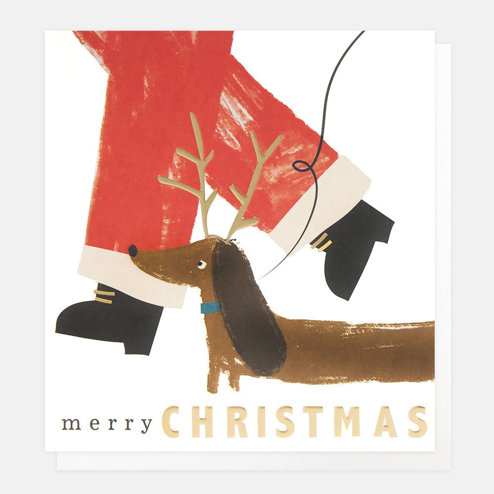 Illustration of a sausage dog with antlers standing next to Santa's legs on a Christmas card.