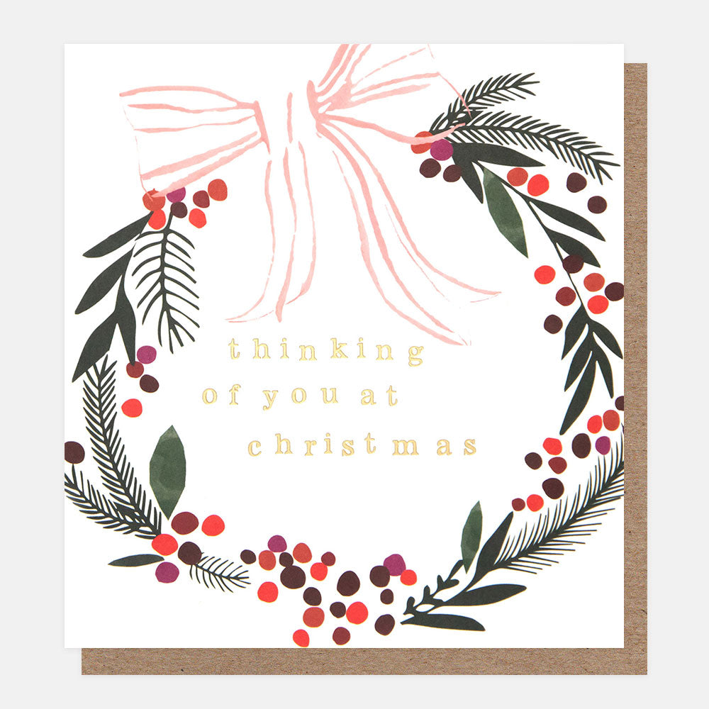 Greeting card with Christmas wreath design and 'thinking of you at Christmas' text.
