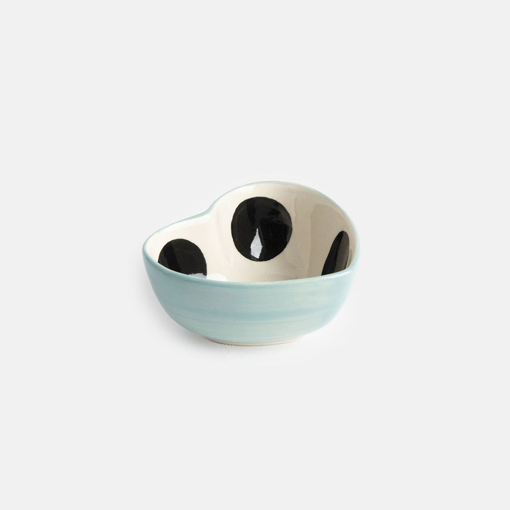 heart shaped hand painted glazed ceramic stoneware trinket bowl qith a black spot inside and light blue outer design