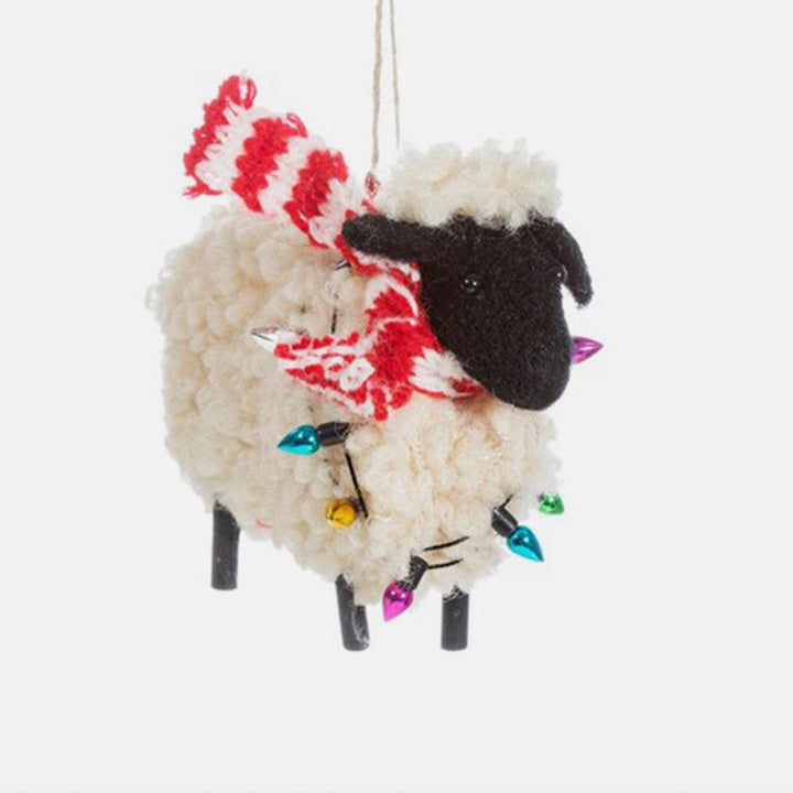wool sheep in red scarf and fairy lights hanging christmas tree decoration