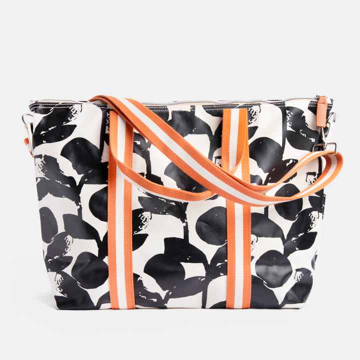 monochrome foliage print coated cotton canvas weekend bag with contrast orange webbing straps