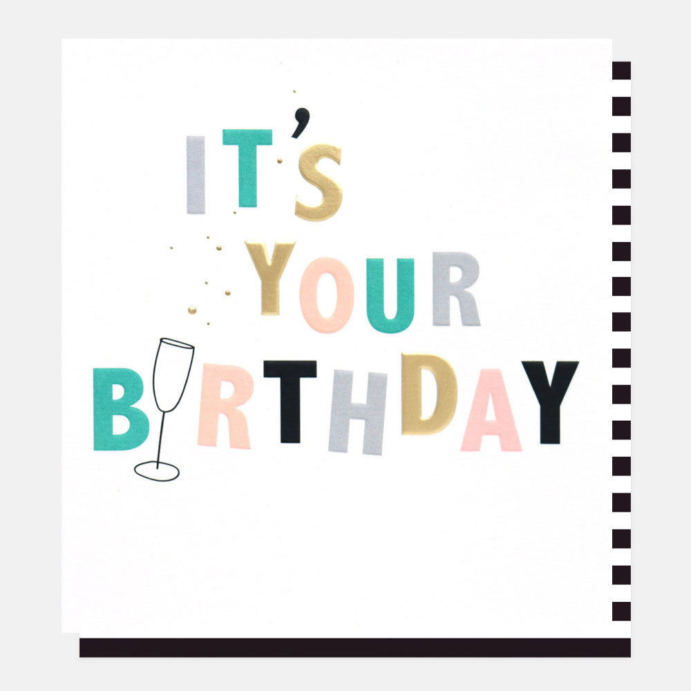 it's your birthday slogan card with multi-coloured lettering and a champagne glass with bubbles design