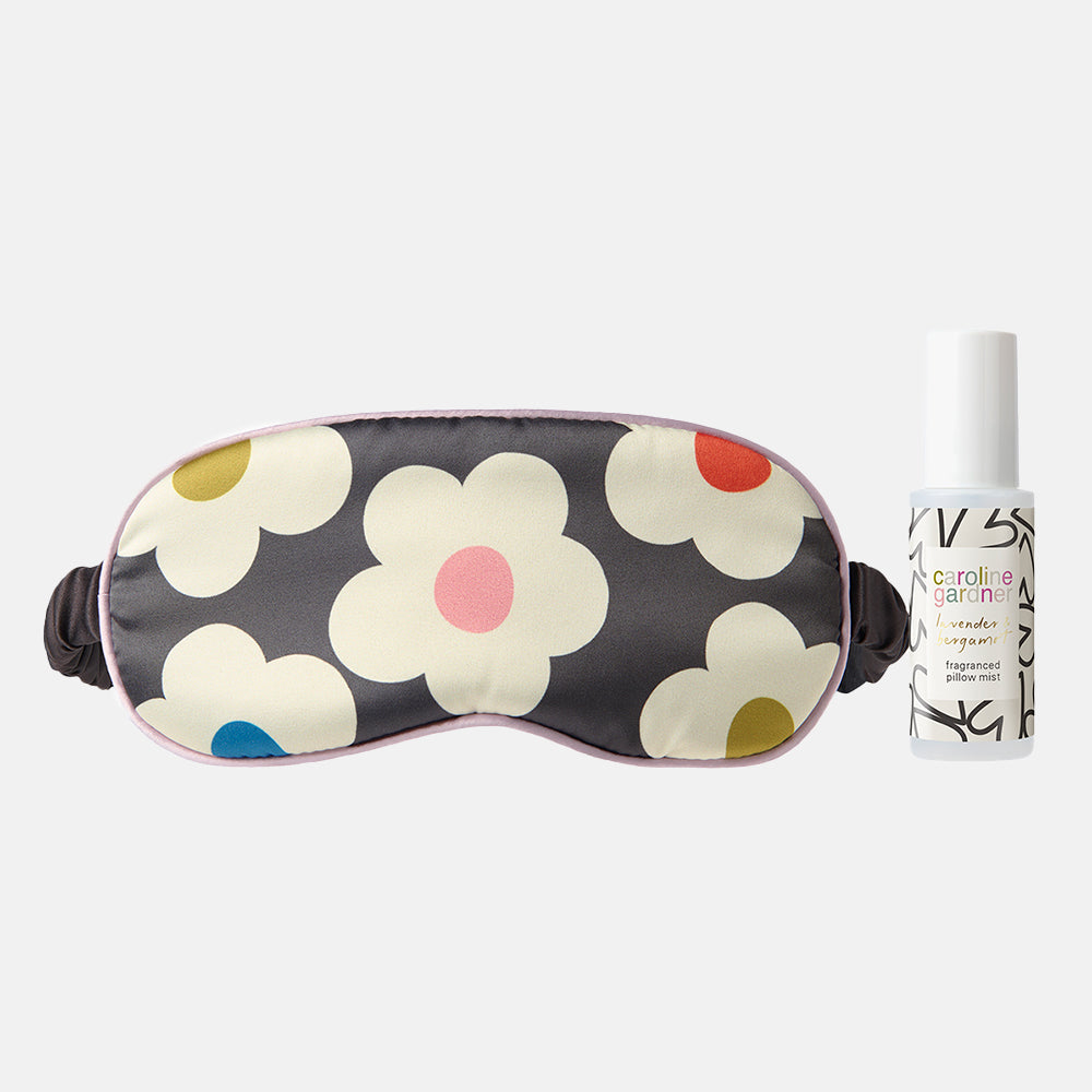 charcoal grey sleep mask with colourful flower print design and lavender & bergamot pillow mist spray