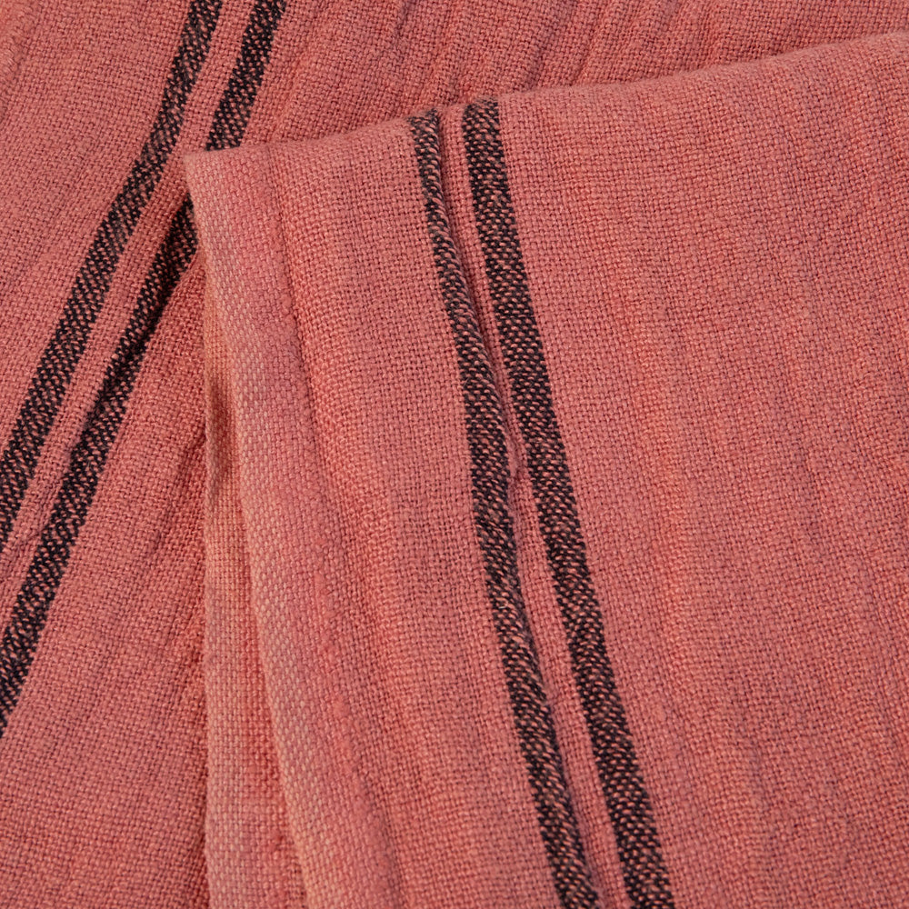 Close-up of pink tea towel with black stripes