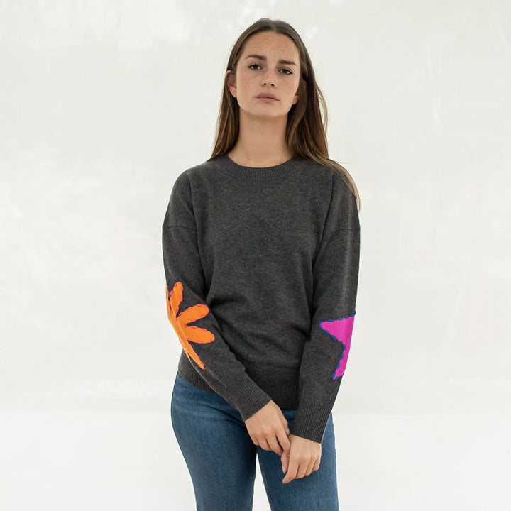 grey crew neck pure cashmere jumper with intarsia embroidered orange and pink shapes on elbows, made by Cocoa cashmere