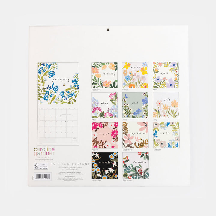 A hanging wall calendar page from Caroline Gardner Portico Designs featuring 12 floral monthly pages and a calendar grid. The pages display various colorful botanical illustrations with month names, shown against a clean white background.