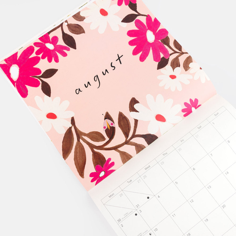 A floral monthly calendar page for August, showing a pink cover decorated with bright pink and white flowers, brown leaves, and the word 'august' in script. Part of the white calendar grid is visible below on a light gray background.