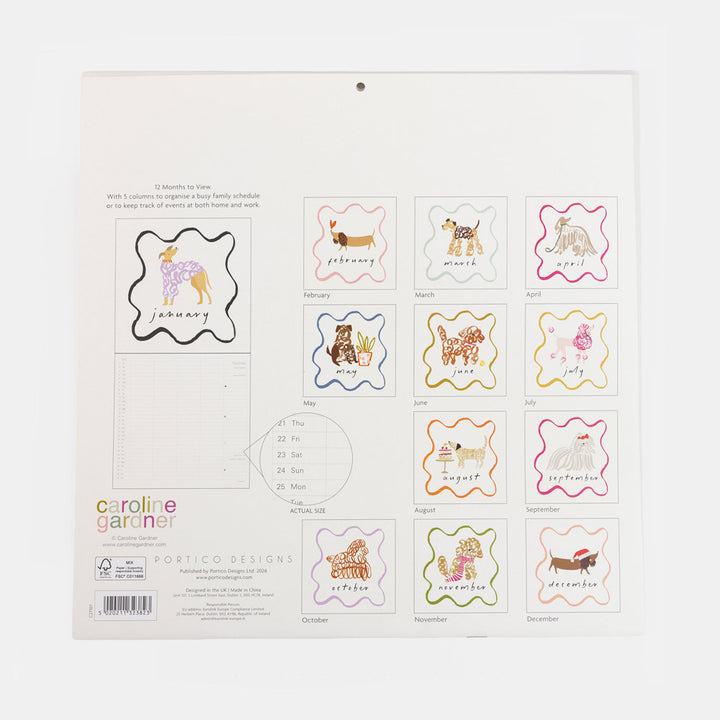 A Caroline Garner 12-month wall calendar page showing the back side with monthly animal-themed stamps and a sample insert, photographed against a white background.