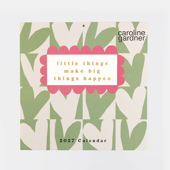 Caroline Gardner 2027 Calendar featuring a retro pattern of green and cream hearts with a central pink scalloped label that reads 'little things make big things happen'.