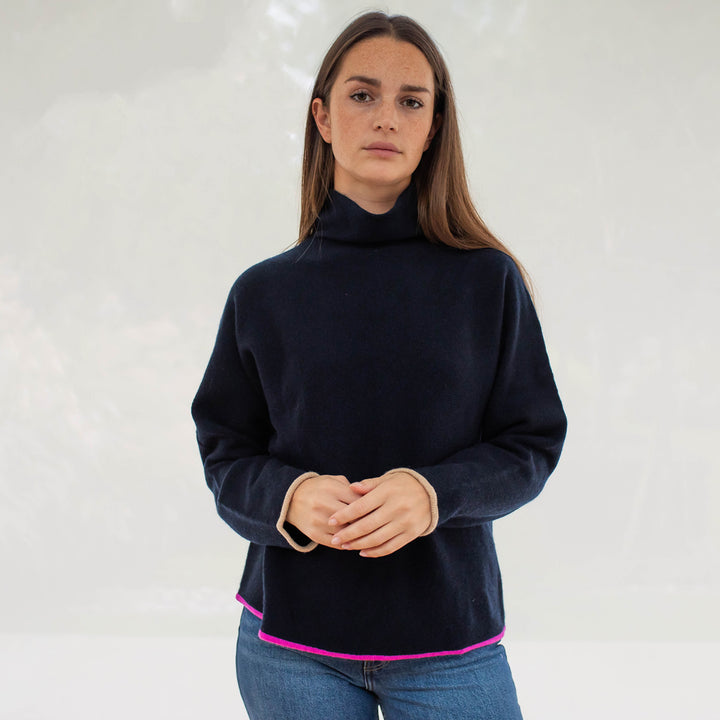 Navy Blue Pure Cashmere funnel neck Jumper with bright pink trim at the waist and camel trim at the wrist, made by Cocoa Cashmere