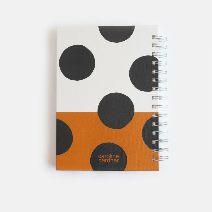 a5 spiral bound hardcover notebook with a big spot print over a cream and tan background design