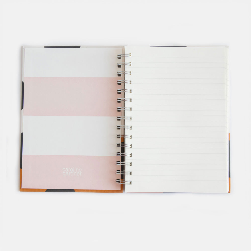 a5 spiral bound hardcover notebook with a pink and cream striped lining and lined pages