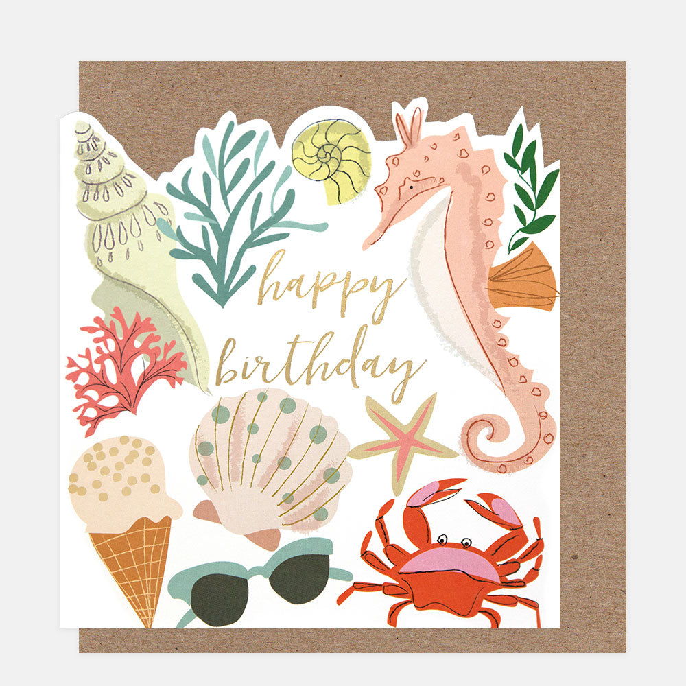 Seaside-themed birthday card with seahorse, crab, shells, and ice cream cone on a white background.