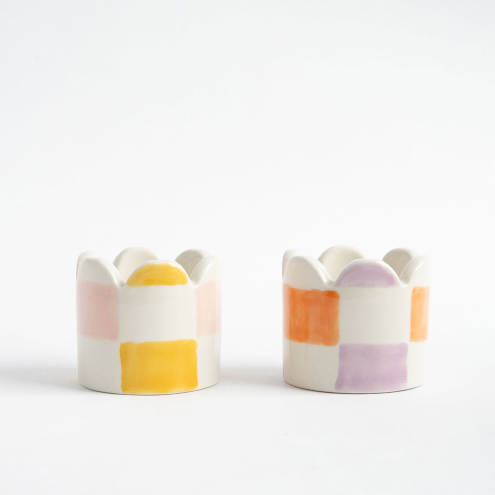 set of 2 hand painted stoneware egg cups in yellow/pink and orange/lilac check designs