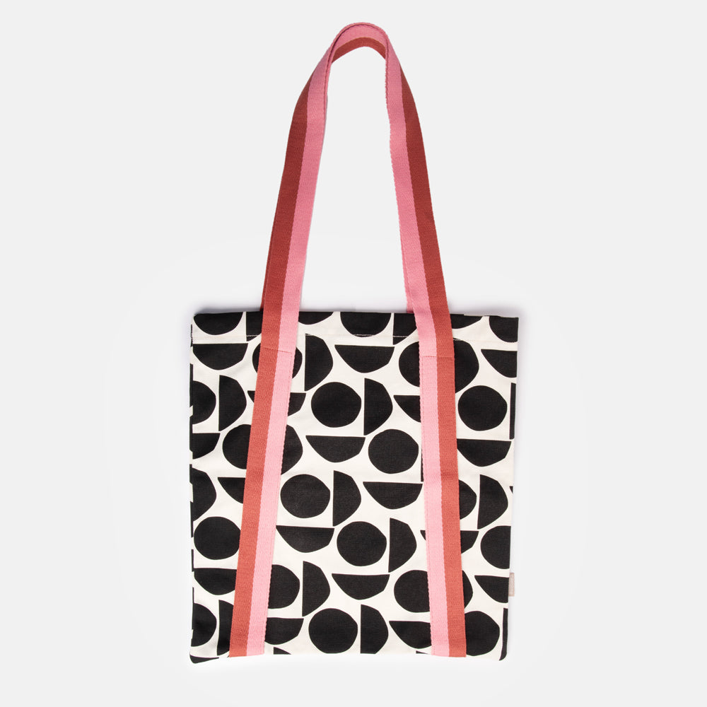 hand printed cotton canvas tote bag with monochrome geometric shapes design and colourful stripe webbing handles