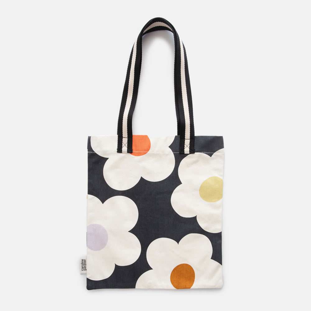 hand printed cotton canvas tote bag with colourful flowers on charcoal design and monochrome stripe webbing handles