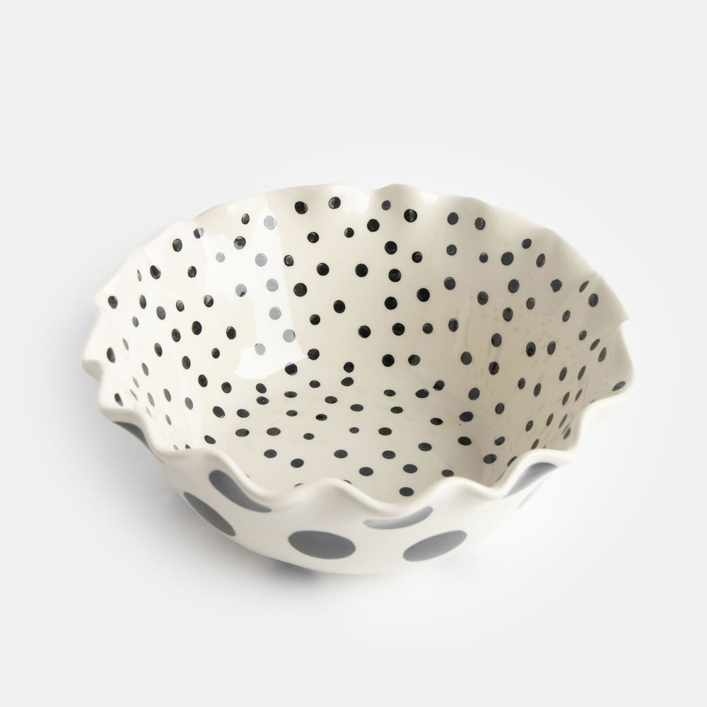 scallop edged ceramic bowl in white with big black spots on the outside and small black dots on the inside