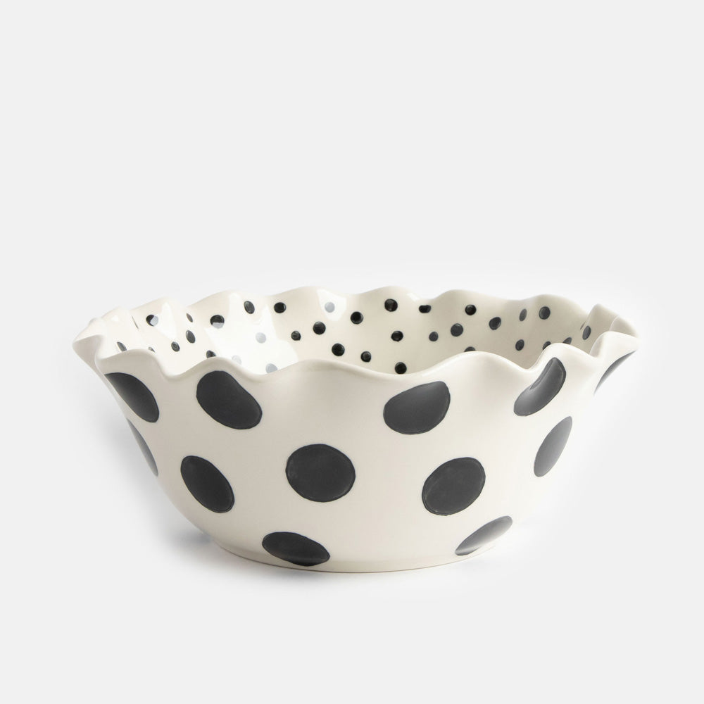 scallop edged ceramic bowl in white with big black spots on the outside and small black dots on the inside