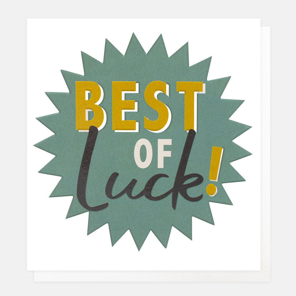 A square greeting card with a white border and a central burst design. The burst is muted teal-green with the words “BEST OF Luck!” in large decorative lettering.
