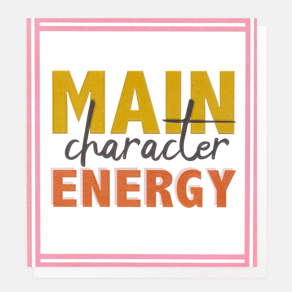 A square greeting card with a white background and pink border, featuring the text 'MAIN character ENERGY' in yellow, dark gray, and orange lettering.