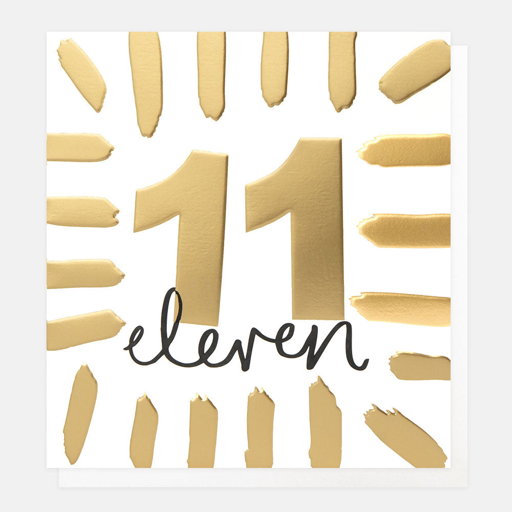 birthday card featuring the number 11 in gold foil and the word 'eleven' in black handwritten style lettering

