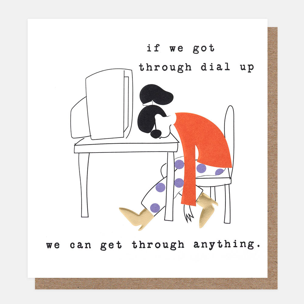 A square white greeting card with an illustration of a woman slumped over a desk with a computer on it and the text 'if we got through dial up we can get through anything'. A brown kraft envelope is partially visible behind the card.
