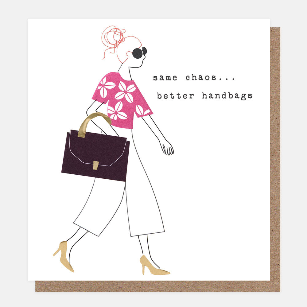 A square greeting card with a white front and a brown kraft envelope behind it. The card features a minimalist line drawing of a woman walking while carrying a dark burgundy handbag, with the text 'same chaos...better handbags'