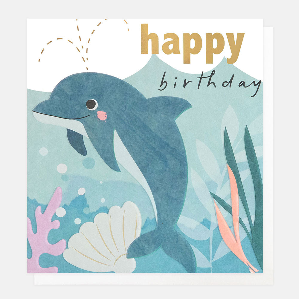 kid's birthday card featuring a blue dolphin with a shell and seaweed and 'happy birthday' text in gold