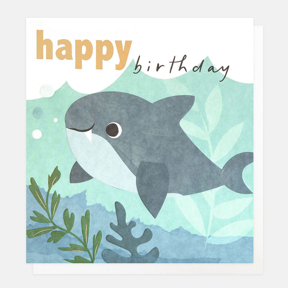 kids birthday card featuring a smiling shark under the waves with seaweed and 'happy birthday' text in gold