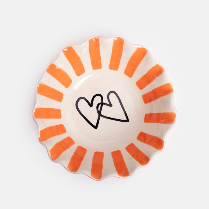 hand painted ceramic stoneware cereal bowl with pink outer, orange stripe internal, scalloped edge and two hearts design inside