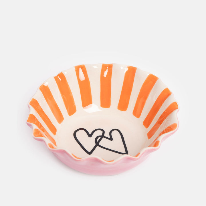 hand painted ceramic stoneware cereal bowl with pink outer, orange stripe internal, scalloped edge and two hearts design inside