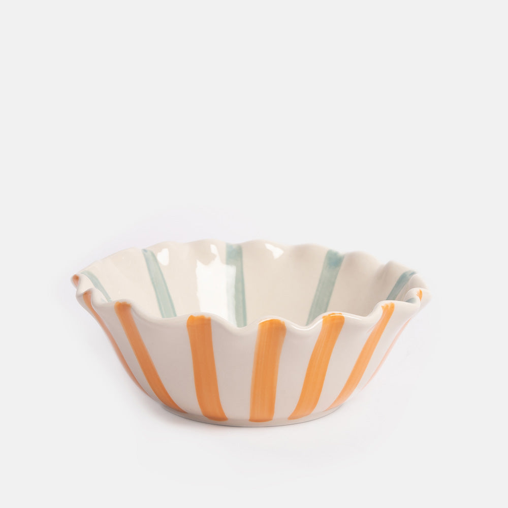 Ceramic bowl with orange stripes on the exterior, blue stripes on the interior, and a scalloped edge