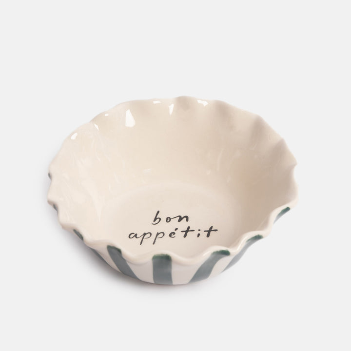 scallop edged bowl with blue stripe exterior and white interior with 'bon appetit' design