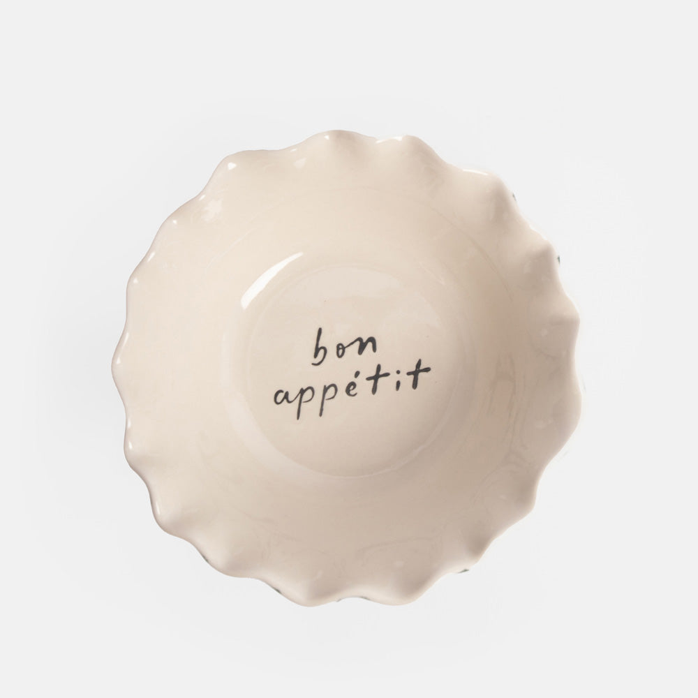 ceramic bowl with white interior and 'bon appeitt' design