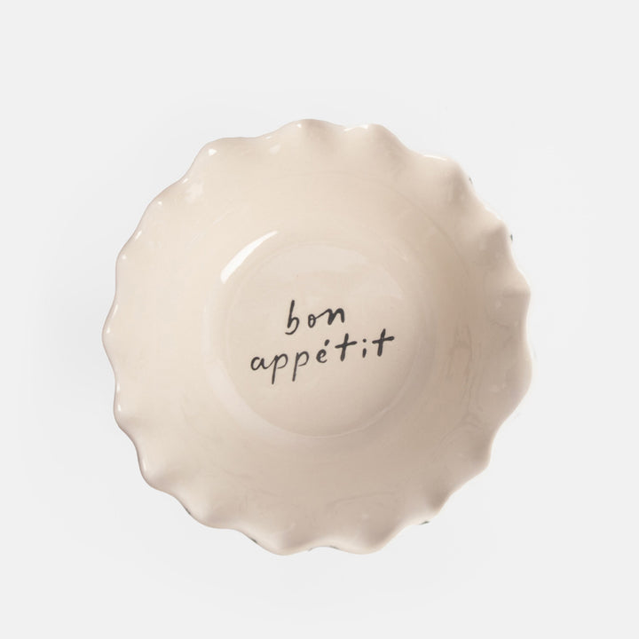 ceramic bowl with white interior and 'bon appeitt' design