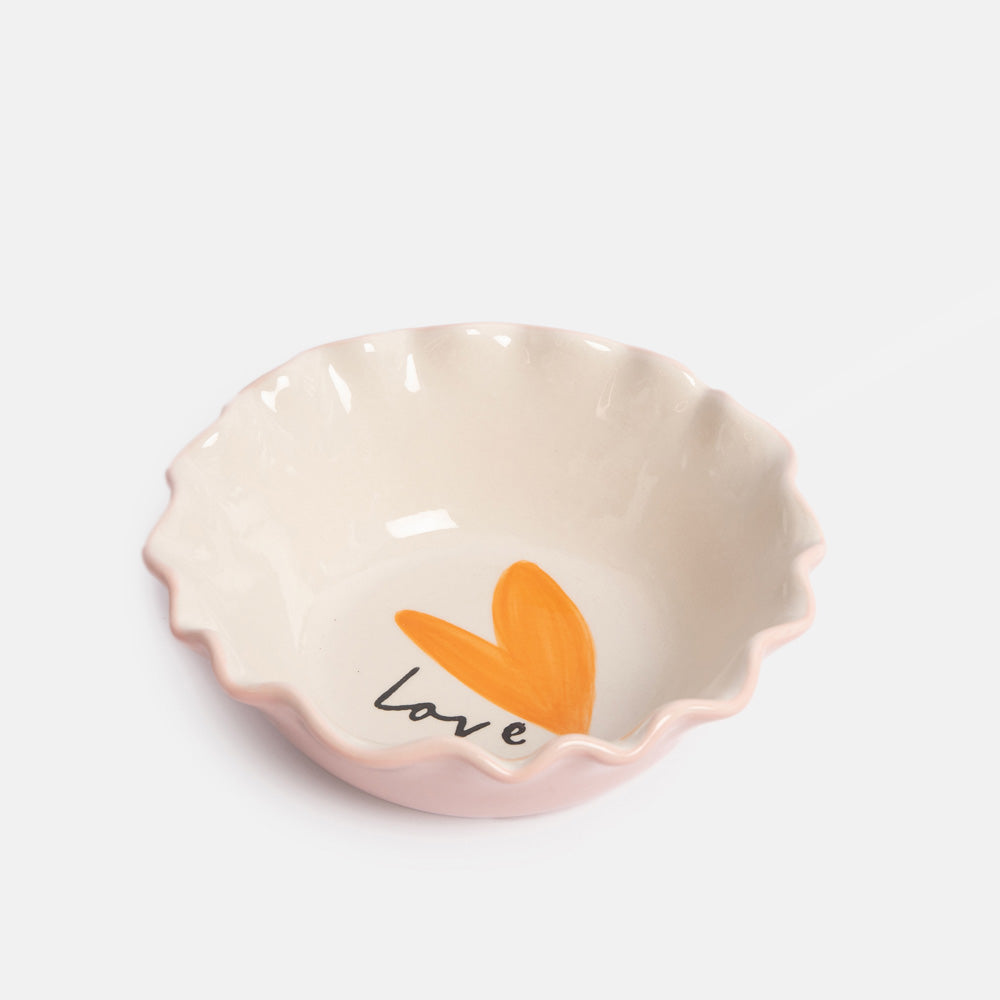 Ceramic bowl with a pink outside and orange heart and 'love' text on white inside