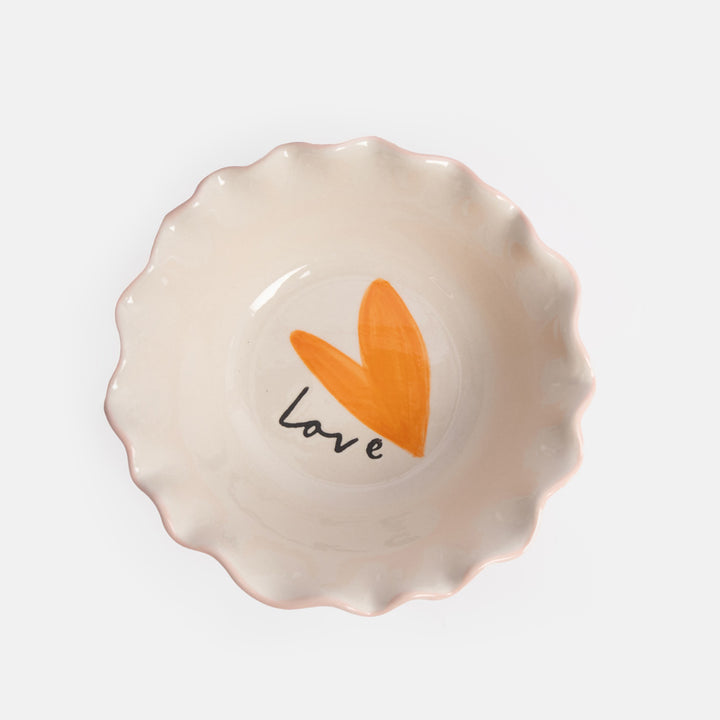 Ceramic bowl with an orange heart and 'love' text on a white background