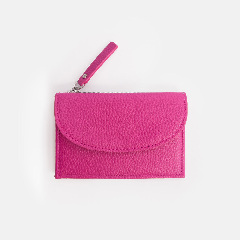 Pink textured wallet with a strap on a white background