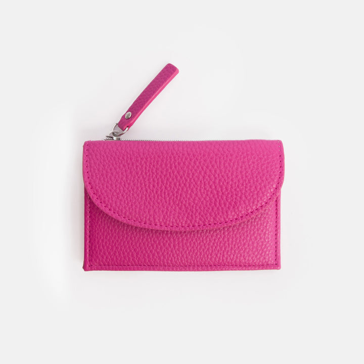 Pink textured wallet with a strap on a white background