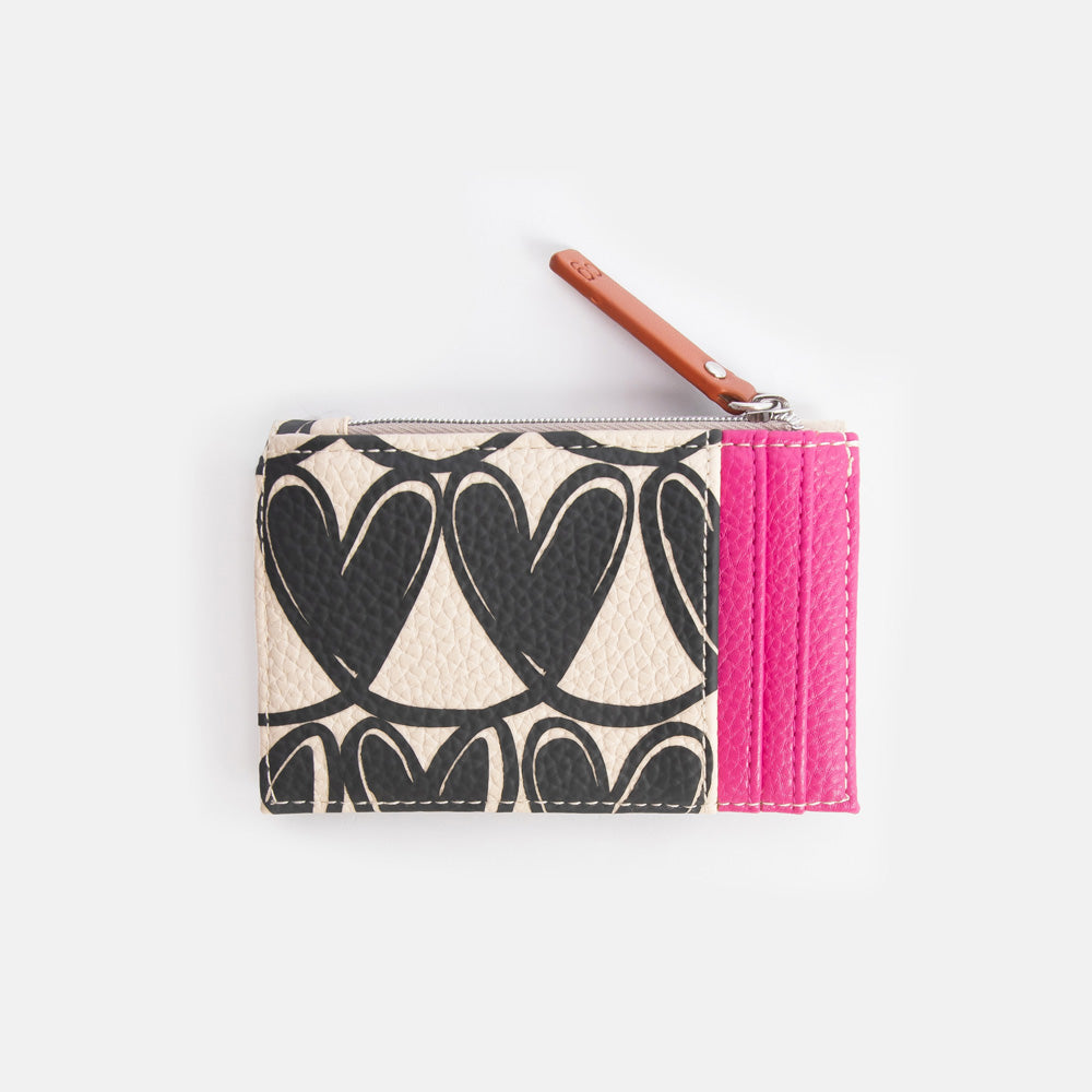 Card holder with heart pattern, brown strap, and pink card slots on a light grey background