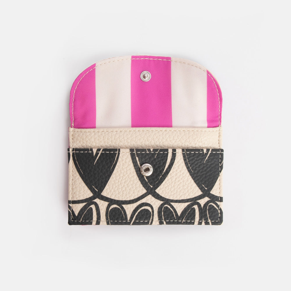 Card holder with heart pattern and pink striped lining on a light grey background