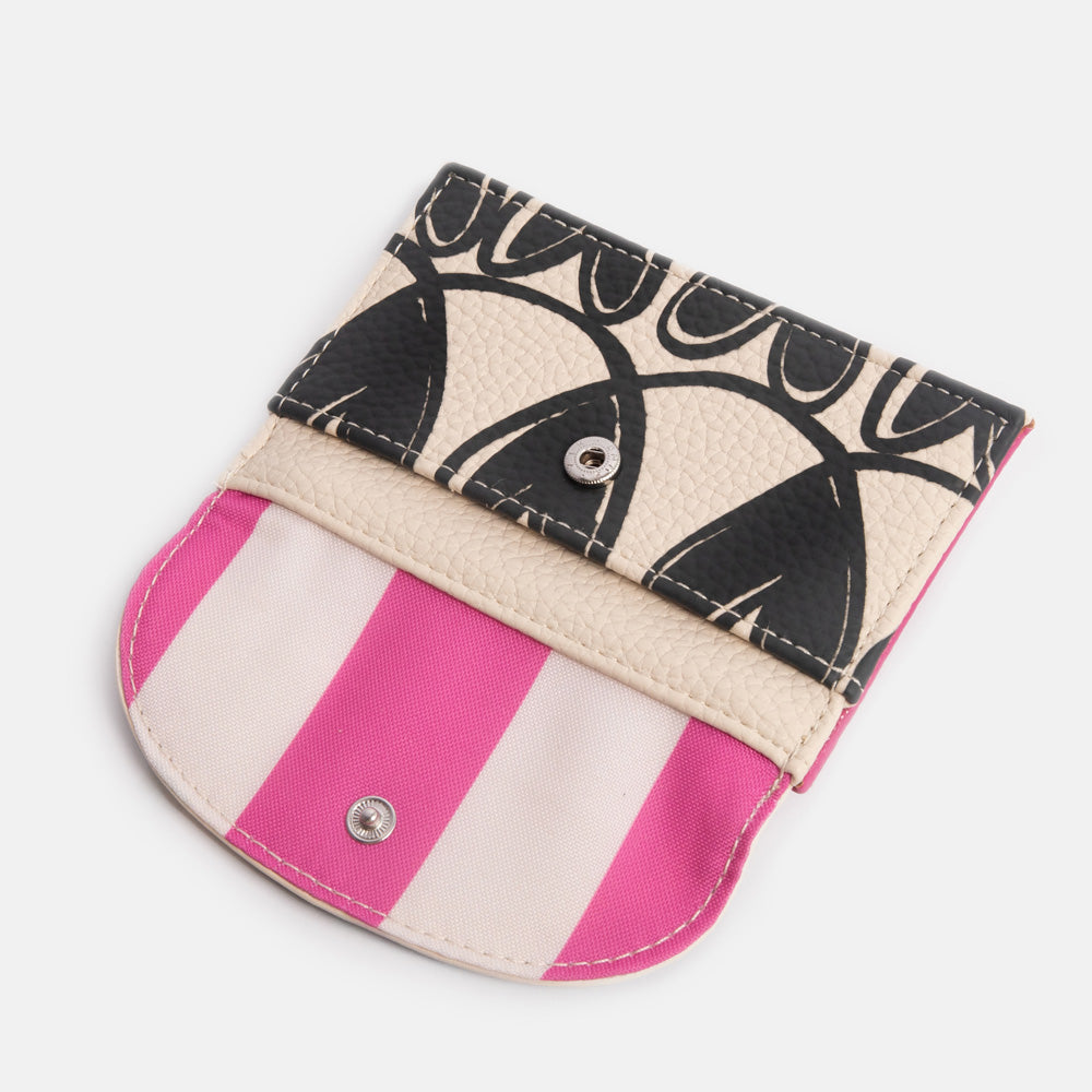 Card holder with heart pattern and pink striped lining on a light grey background