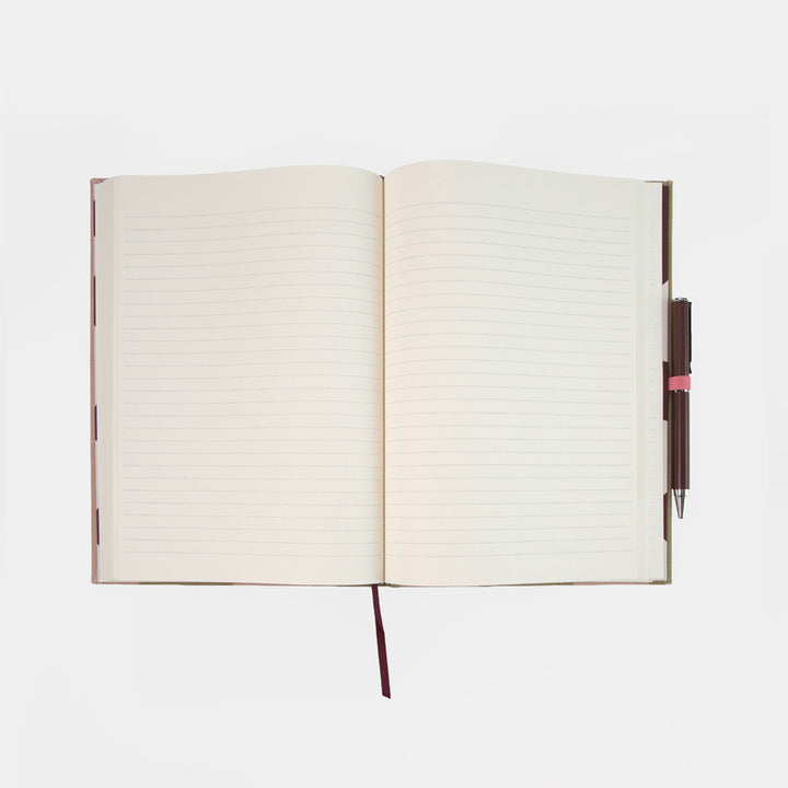 an open lined notebook with a burgundy pen