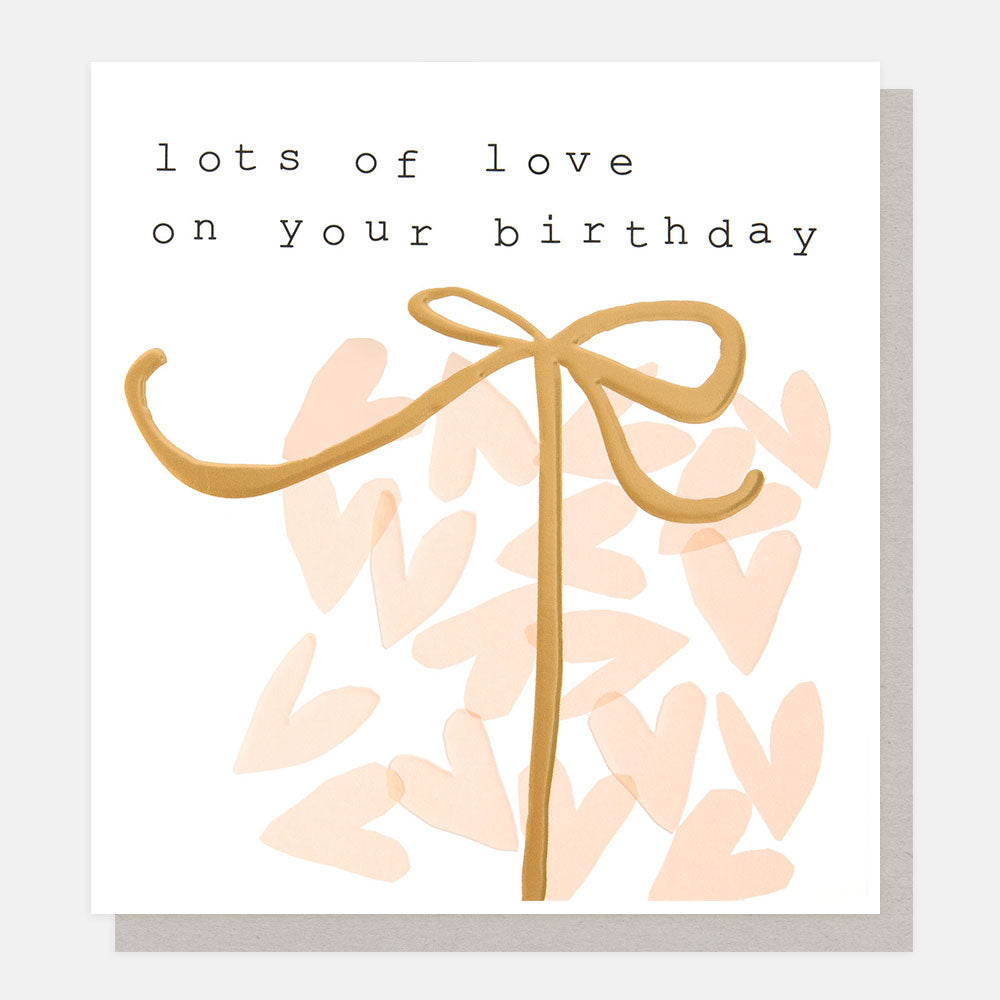 birthday card featuring pink hearts in a present shape with gold ribbon tie and text 'lots of love on your birthday'