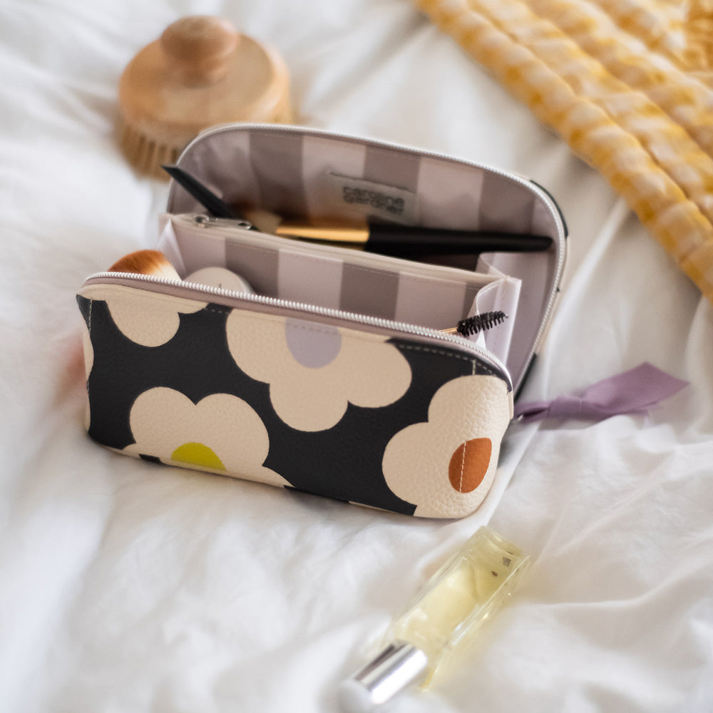 leather look PU lay flat cosmetics bag in multi flower charcoal design with striped wipe clean lining, silver zip and lilac grosgrain pull
