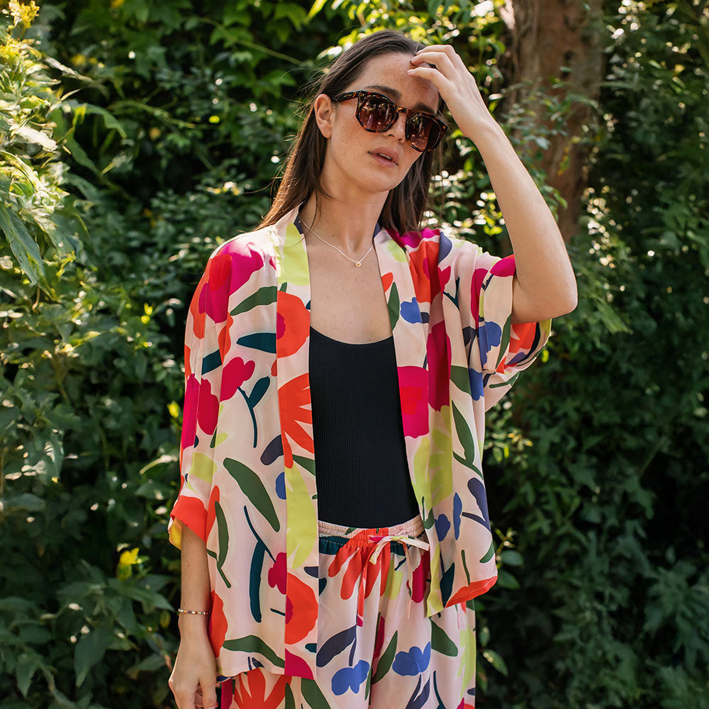 colourful abstract floral print silk short kimono top on a pale pink base