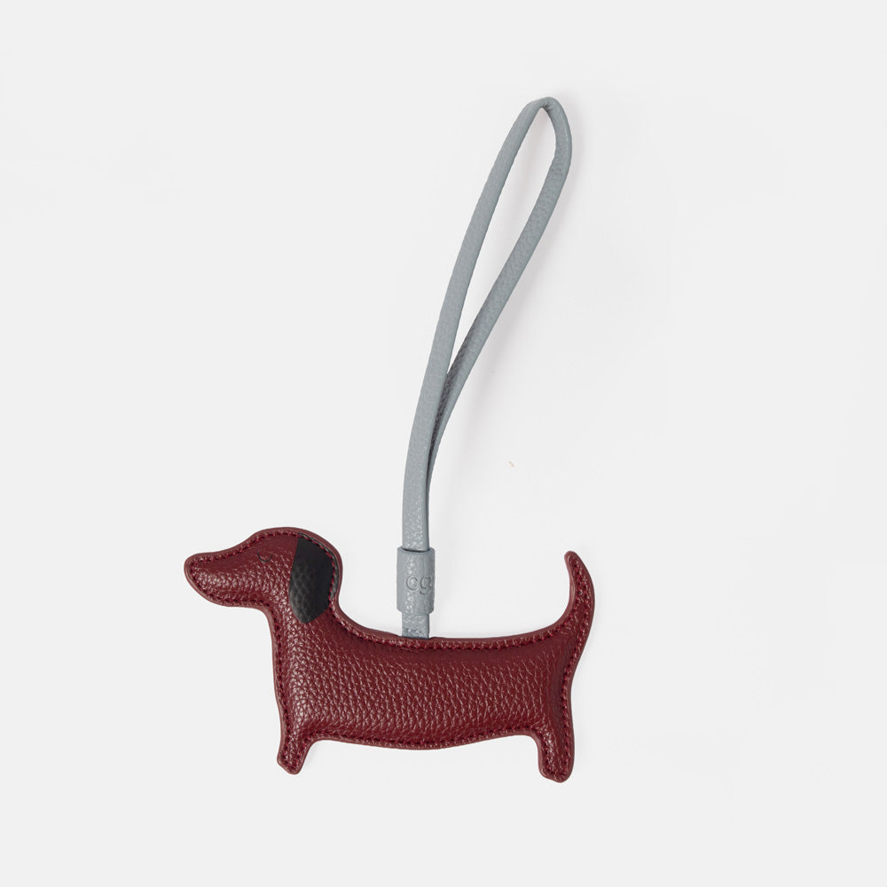 burgundy sausage dog bag charm with a silver strap